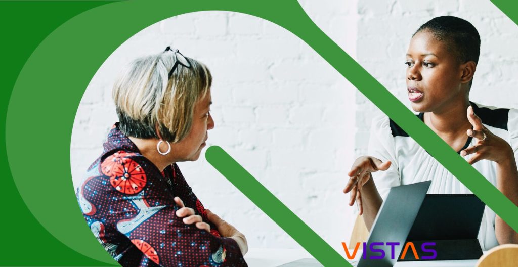 Two women in discussion, Vistas logo.